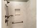 Walk-in shower with marble-look walls and bronze fixtures at 2078 Pink Blossom Ct, The Villages, FL 32162