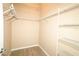 Spacious walk-in closet with wire shelving and hanging rods at 2078 Pink Blossom Ct, The Villages, FL 32162