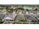 Aerial view of a residential neighborhood with houses, golf course, and lake at 2096 Odessa Cir, The Villages, FL 32162