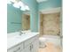 Bathroom with white vanity, bathtub and teal walls at 2096 Odessa Cir, The Villages, FL 32162