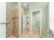 Walk-in shower with grab bars and tiled walls at 2096 Odessa Cir, The Villages, FL 32162