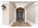 Inviting entryway with a stone path and arched doorway at 2096 Odessa Cir, The Villages, FL 32162