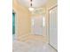 Neutral-toned entryway with tile floor, coat closet, and interior door at 2096 Odessa Cir, The Villages, FL 32162