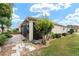 Home's exterior showcasing landscaping and paver walkway at 2096 Odessa Cir, The Villages, FL 32162