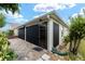 Exterior view of home with screened patio and paver driveway at 2096 Odessa Cir, The Villages, FL 32162