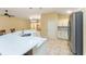 Kitchen features a large island with seating and stainless steel appliances at 2096 Odessa Cir, The Villages, FL 32162