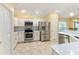 Modern kitchen featuring stainless steel appliances and light cabinets at 2096 Odessa Cir, The Villages, FL 32162