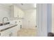 Laundry room with cabinets, sink and built-in shelving at 2096 Odessa Cir, The Villages, FL 32162