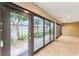 Bright sunroom with glass doors opening to a well-landscaped backyard at 2096 Odessa Cir, The Villages, FL 32162