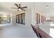 Large covered porch with ceiling fan and outdoor swing at 211 Cassady St, Umatilla, FL 32784