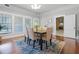 Dining room with hardwood floors, a large table, and view of kitchen at 211 Cassady St, Umatilla, FL 32784