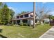 Charming two-story home with a spacious lawn and mature trees at 211 Cassady St, Umatilla, FL 32784