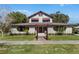 Charming two-story home with unique architectural features and manicured landscaping at 211 Cassady St, Umatilla, FL 32784
