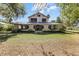 Charming two-story house with mature landscaping at 211 Cassady St, Umatilla, FL 32784