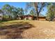 House with a large backyard and covered patio at 2187 County Road 243C, Wildwood, FL 34785