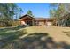 Home exterior view with a large covered patio and pergola at 2187 County Road 243C, Wildwood, FL 34785