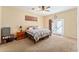 Spacious primary bedroom with a king-size bed and access to the backyard at 2187 County Road 243C, Wildwood, FL 34785