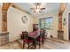 Dining room with a wooden table, red chairs, and hardwood floors at 2187 County Road 243C, Wildwood, FL 34785