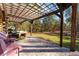 Spacious covered patio with pergola and seating area at 2187 County Road 243C, Wildwood, FL 34785