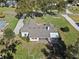 Aerial view of house, showing roof, screened porch, and large backyard at 23720 Sundance Dr, Sorrento, FL 32776