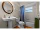 Clean bathroom with pedestal sink, toilet, and tub shower at 23720 Sundance Dr, Sorrento, FL 32776