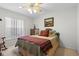 Cozy bedroom with a comfortable bed and a ceiling fan at 23720 Sundance Dr, Sorrento, FL 32776