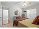 Bedroom with bed, dresser, and access to another room at 23720 Sundance Dr, Sorrento, FL 32776