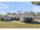 Front view of the house, showcasing a well-maintained lawn at 23720 Sundance Dr, Sorrento, FL 32776