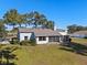 Single-story home with a screened porch and large backyard at 23720 Sundance Dr, Sorrento, FL 32776