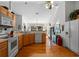 View of kitchen, featuring wood floors and stainless steel appliances at 23720 Sundance Dr, Sorrento, FL 32776