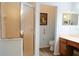 Clean bathroom featuring a glass shower, toilet, and vanity with storage at 24308 Belle Mede Dr, Leesburg, FL 34748