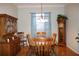 Traditional dining room boasts wood furniture and a charming chandelier at 24308 Belle Mede Dr, Leesburg, FL 34748