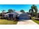 Well maintained single-story home with 3 car garage and mature tropical landscaping at 24308 Belle Mede Dr, Leesburg, FL 34748