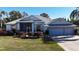 Single-story house with two-car garage and mature landscaping at 24308 Belle Mede Dr, Leesburg, FL 34748