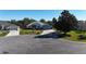 Single-story home with two-car garage and corner lot view at 24308 Belle Mede Dr, Leesburg, FL 34748