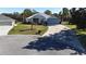 Single-story house with a two-car garage and corner lot view at 24308 Belle Mede Dr, Leesburg, FL 34748