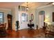 Bright foyer showcasing hardwood floors, transom windows, and a decorative front door at 24308 Belle Mede Dr, Leesburg, FL 34748