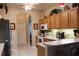 Charming kitchen with oak cabinets, white appliances, tiled floors, and decorative rooster accents at 24308 Belle Mede Dr, Leesburg, FL 34748