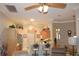 Kitchen with breakfast bar, wood cabinets, and view of living room at 24308 Belle Mede Dr, Leesburg, FL 34748