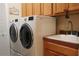 Laundry room with washer, dryer, and utility sink at 24308 Belle Mede Dr, Leesburg, FL 34748