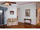 Cozy living room with hardwood floors, archway, ceiling fan and natural light at 24308 Belle Mede Dr, Leesburg, FL 34748