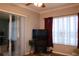 Living room featuring a fireplace and sliding glass doors to the outdoor living area at 24308 Belle Mede Dr, Leesburg, FL 34748