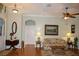 Living room with hardwood floors, floral sofa and wood accent table at 24308 Belle Mede Dr, Leesburg, FL 34748