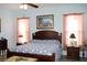 Spacious main bedroom with king-size bed and light walls at 24308 Belle Mede Dr, Leesburg, FL 34748