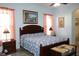 Spacious main bedroom with a large bed, ceiling fan, and decorative art at 24308 Belle Mede Dr, Leesburg, FL 34748