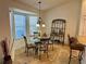 Bright dining area with glass table and four chairs at 2458 Dunkirk Trl, The Villages, FL 32162