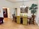 Bright dining room featuring an oval table and hardwood floors at 2458 Dunkirk Trl, The Villages, FL 32162