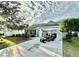 Home exterior with golf cart and palm tree accents in the driveway at 2458 Dunkirk Trl, The Villages, FL 32162