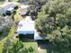 An aerial view showcasing a house's exterior and surrounding landscape at 25143 Barrow Hl, Leesburg, FL 34748