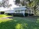 Side view of a single story home with landscaping at 25143 Barrow Hl, Leesburg, FL 34748